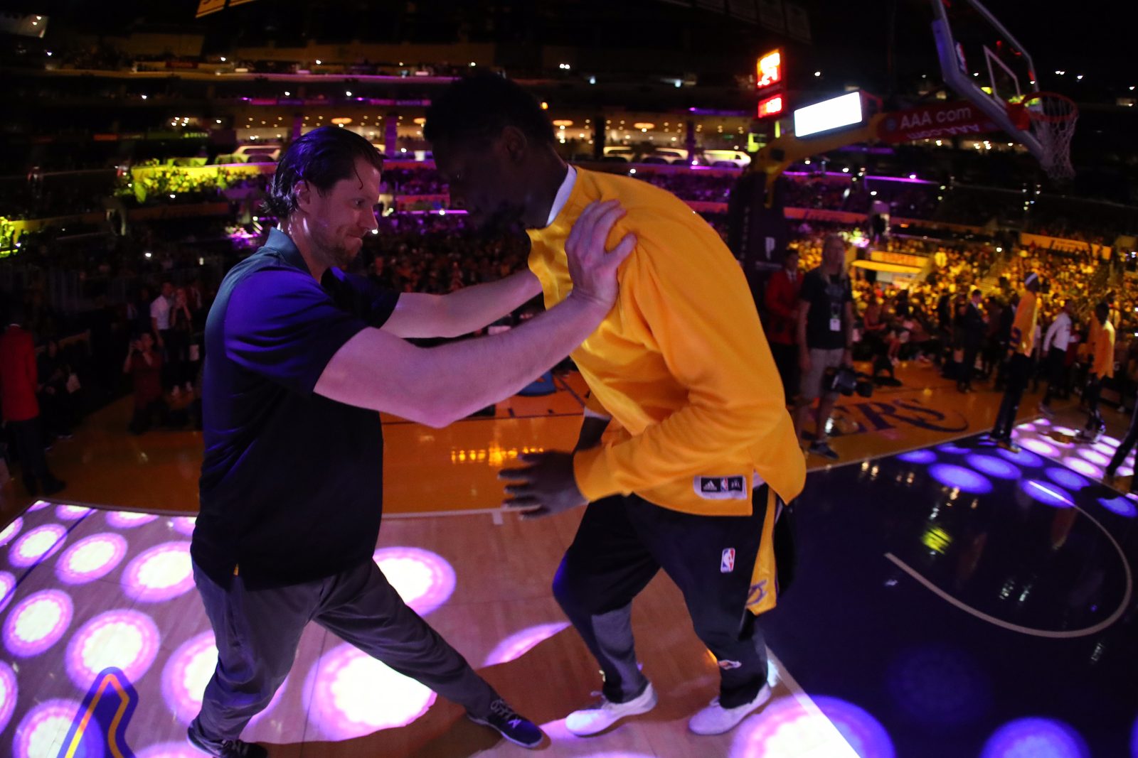 A coach preparing a professional basketball player before tip-off